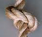 Close-up of a Turk's head knot tied in a thick, natural fiber manila climbing rope.