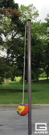 Tetherball system with a tall metal pole and a yellow, red, and purple ball on a rope.