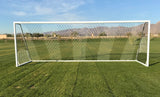 White aluminum soccer goal with a hexagonal net on a green field.