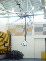 Ceiling-hung basketball backstop with a white backboard and red rim in a gymnasium.