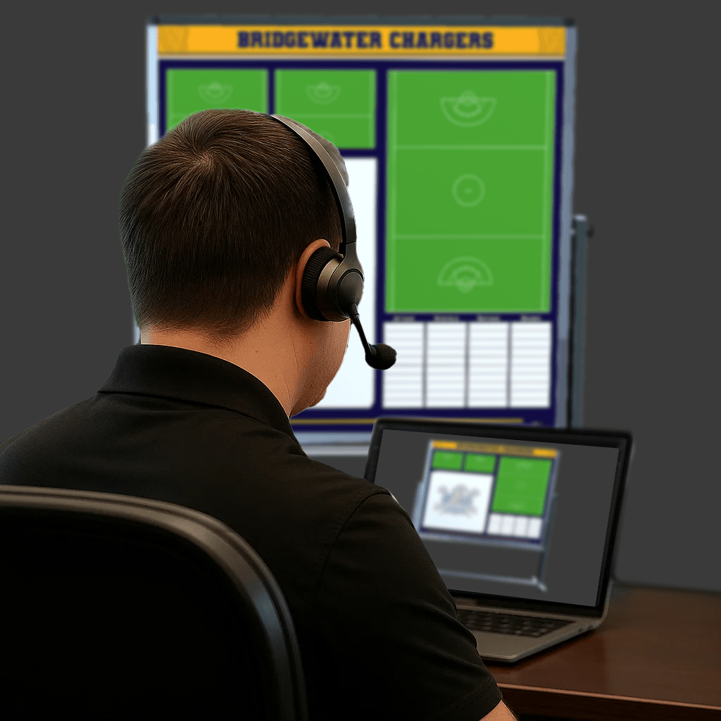 Back view of a customer support representative wearing a headset while assisting with the design of a custom Hockey whiteboard, shown on a laptop and a large screen.