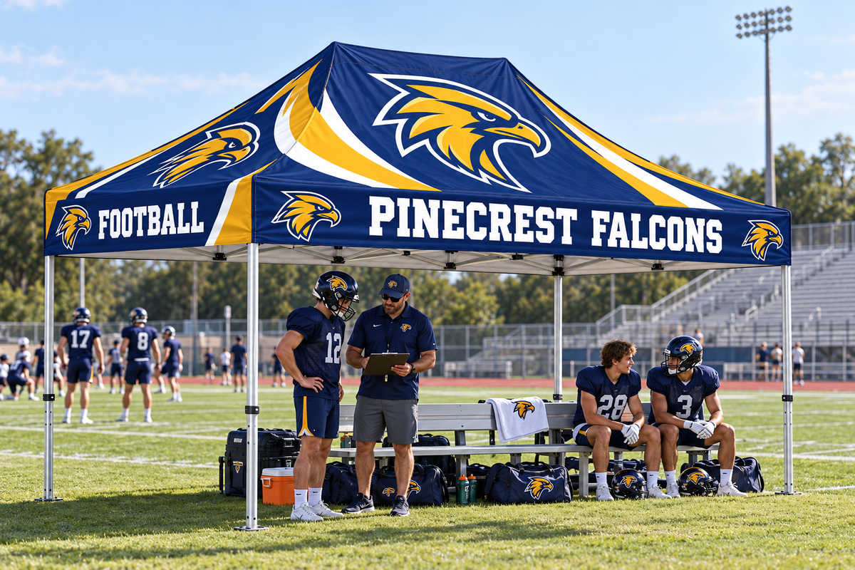 School coach and athletes regroup beneath a coordinated custom team tent.