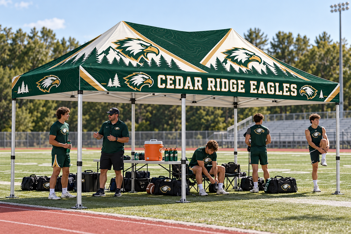 School coach and athletes regroup beneath a coordinated custom team tent.