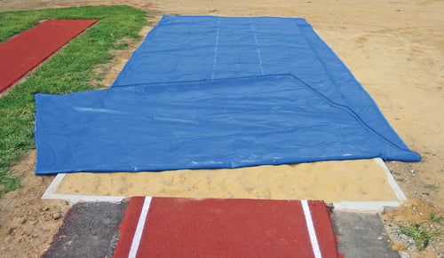 FieldSaver weighted long jump sand pit cover folded back to reveal built-in weighted perimeter edge that secures jump pit cover without stakes or sandbags