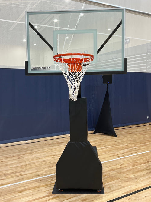 Portable basketball hoop with clear backboard, orange rim, and white net on a wooden court.