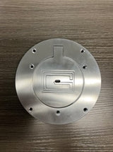 Round, brushed chrome cover plate with a "G" logo and 6 screw holes.