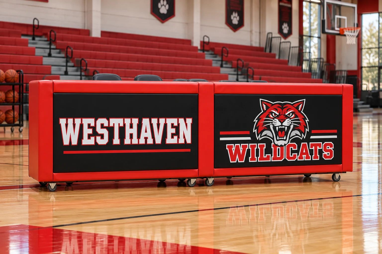 Red and black Westhaven Wildcats custom padded rolling scorers table in a school basketball gym