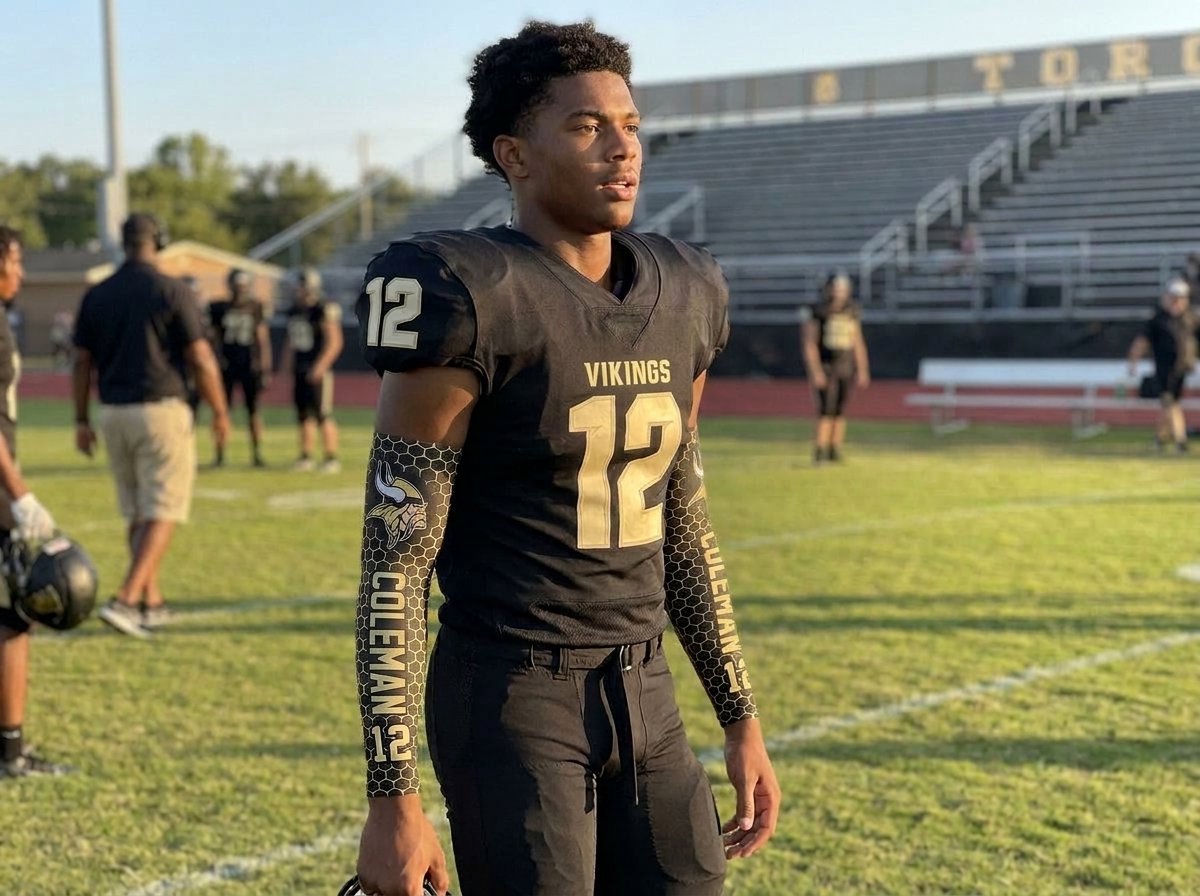 Youth football player in full uniform standing on the field