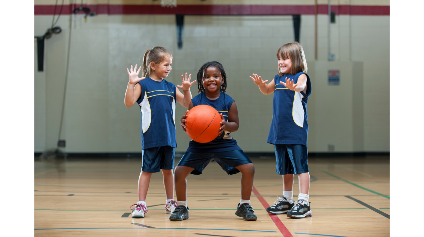 Youth basketball players running a drill, simple plays coaches can teach