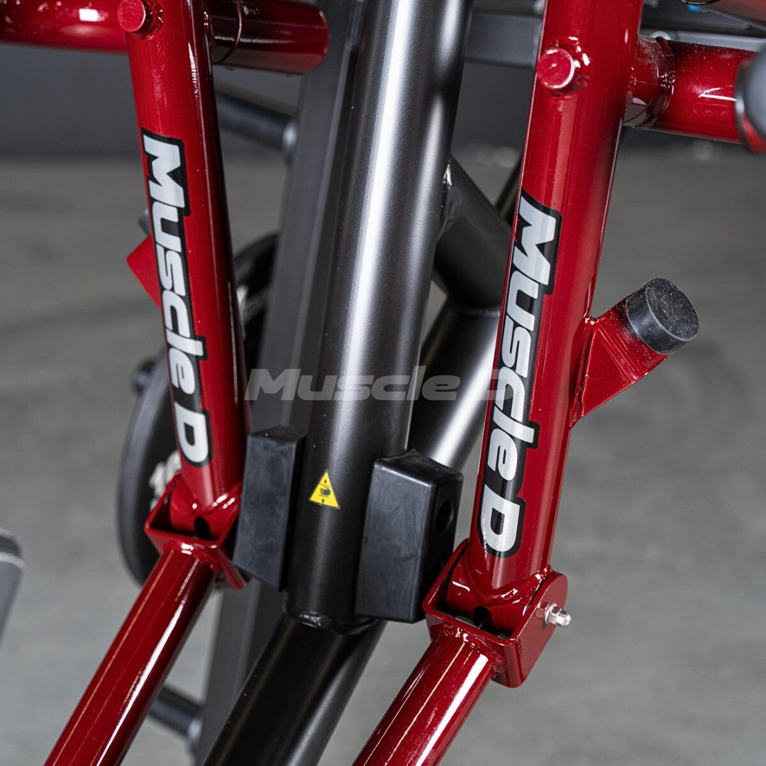 Close-up of red and black gym equipment with "Muscle D" logo.