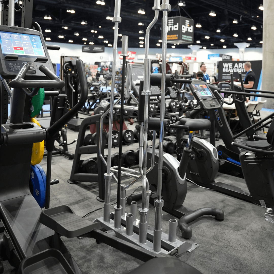 Vertical Olympic bar rack holding 5 bars in a gym setting.