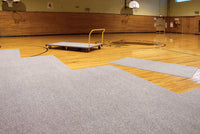 Thumbnail for Carpet tiles being deployed on a hardwood gym floor