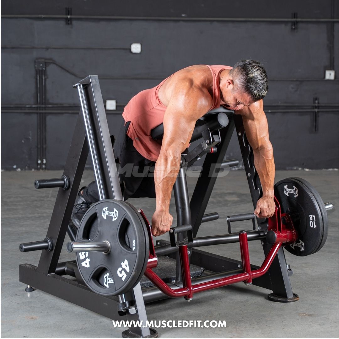 Man performing a chest-supported row exercise on a linear bearing row machine with weight plates.