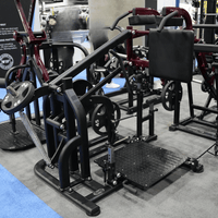 Thumbnail for Black and maroon plate-loaded squat machine with a diamond plate foot platform and padded shoulder rests.