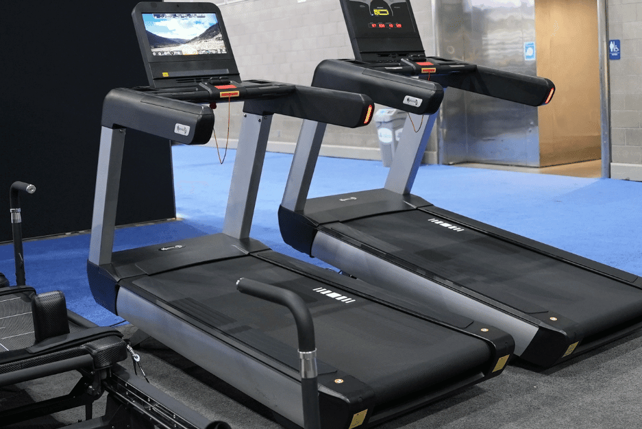 Two V2 Touch Screen Commercial Treadmills with black belts and gray frames.