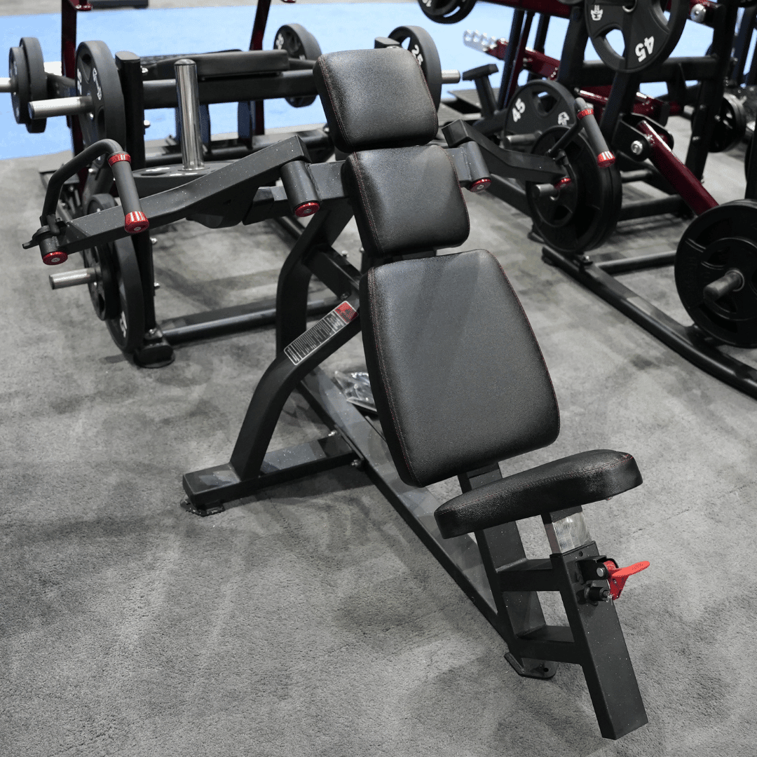 Black plate-loaded incline pec fly machine with adjustable seat and red accents in a gym.