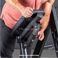 Thumbnail for Man adjusting the padded chest support of a black linear bearing row machine.