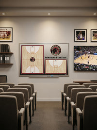 Thumbnail for Custom basketball whiteboard with team logo and court diagrams in a locker room setting with rows of chairs.