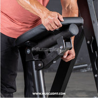 Thumbnail for Man adjusting the black padded chest support of a linear bearing row machine.