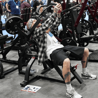 Thumbnail for Man with tattoos and bandana using a plate-loaded incline pec fly machine.