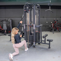 Thumbnail for Woman doing a cable exercise on a black 4-stack jungle gym with weight stacks and a lat pulldown bar.