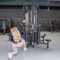 Thumbnail for Woman using a 4-stack cable jungle gym with a single handle, in a gym setting.