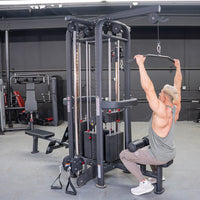 Thumbnail for Man doing lat pulldown on a 4-stack jungle gym with multiple pulleys and weight stacks in a gym.