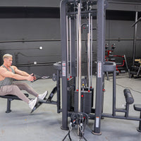 Thumbnail for Man doing a low row on a 4-stack jungle gym machine with multiple weight stacks and pulleys in a gym.