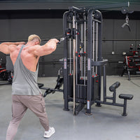 Thumbnail for Man in gray tank top using a 4-stack jungle gym with cable pulleys for a rear delt exercise.