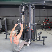 Thumbnail for Man performing a low row exercise on a black 4-stack jungle gym with multiple pulleys and weight stacks.