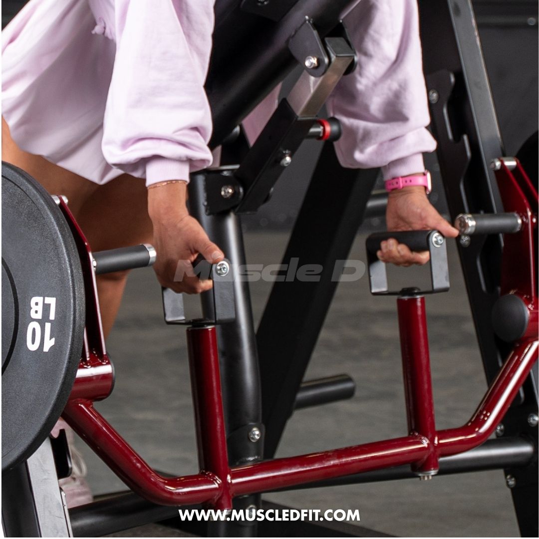 Person adjusting the handles of a red and black chest-supported row machine with a 10lb weight plate.