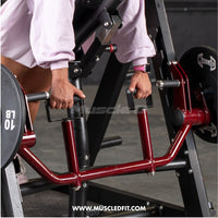 Thumbnail for Person using a red chest-supported linear bearing row machine with weight plates.