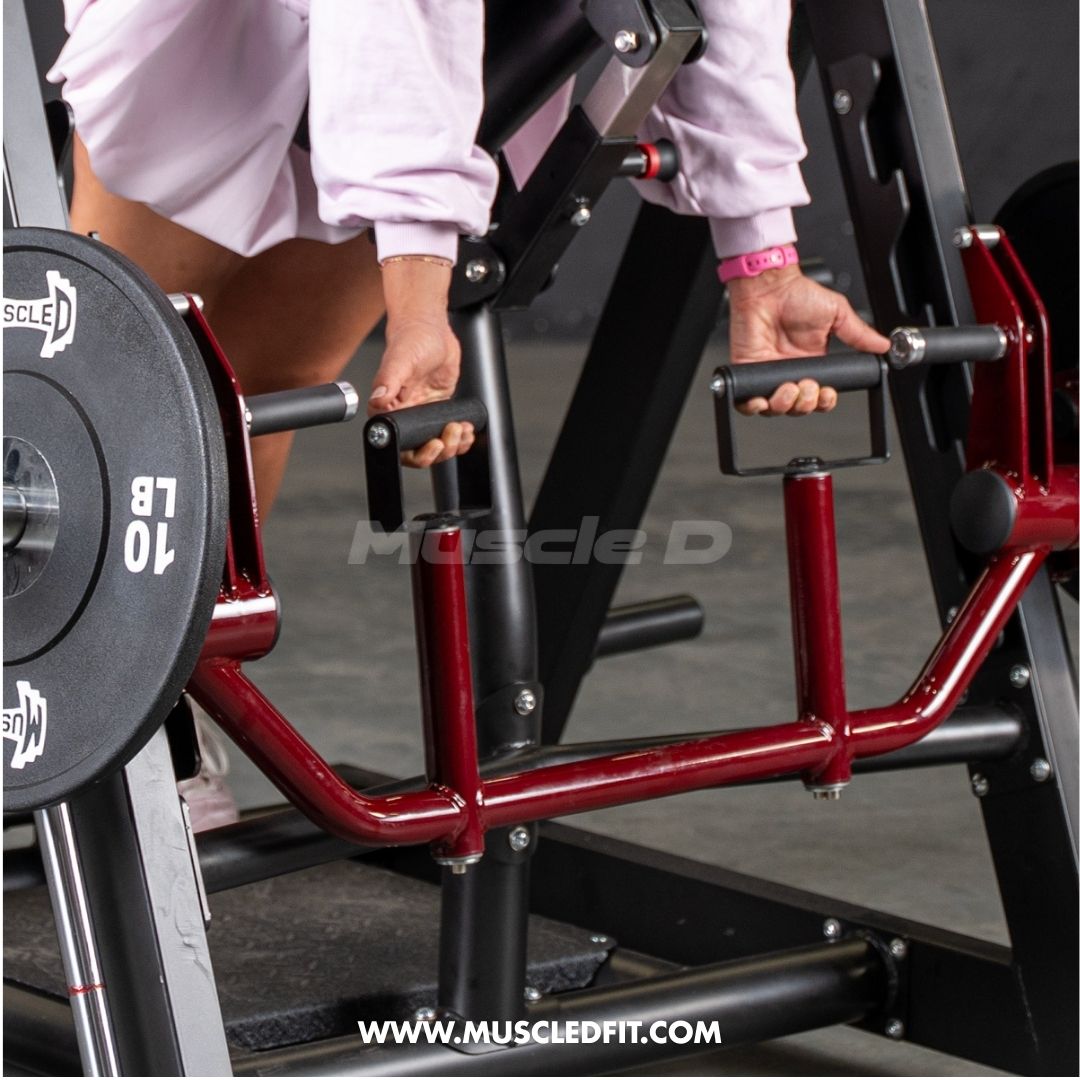 Person gripping handles of a red and black chest-supported row machine with a weight plate.