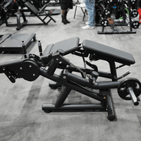 Thumbnail for Black plate-loaded leg extension/curl machine with gray pads in a gym setting.