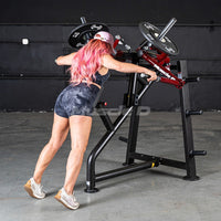 Thumbnail for Woman with pink hair using a red and black rear delt machine in a gym.