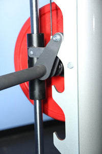 Thumbnail for Close-up of a Smith machine's safety catch mechanism, barbell, and red weight plate.