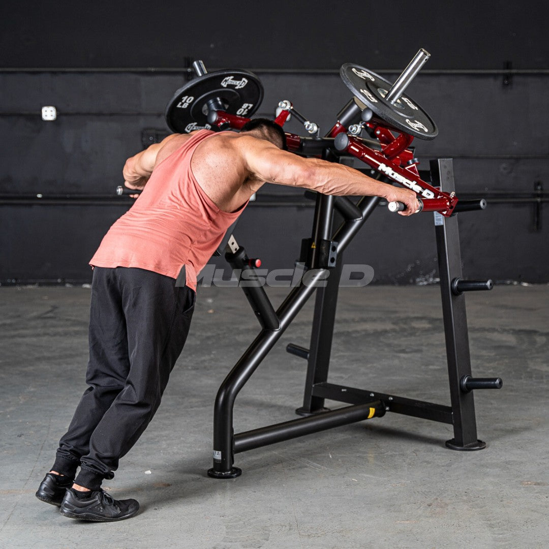 Man using a red and black rear delt machine with weight plates in a gym.