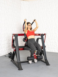 Thumbnail for Woman in red top and gray leggings using a seated plate-loaded abdominal crunch machine.