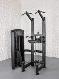 Thumbnail for Black assisted chin/dip machine with weight stack, multiple grip handles, and foot platforms.