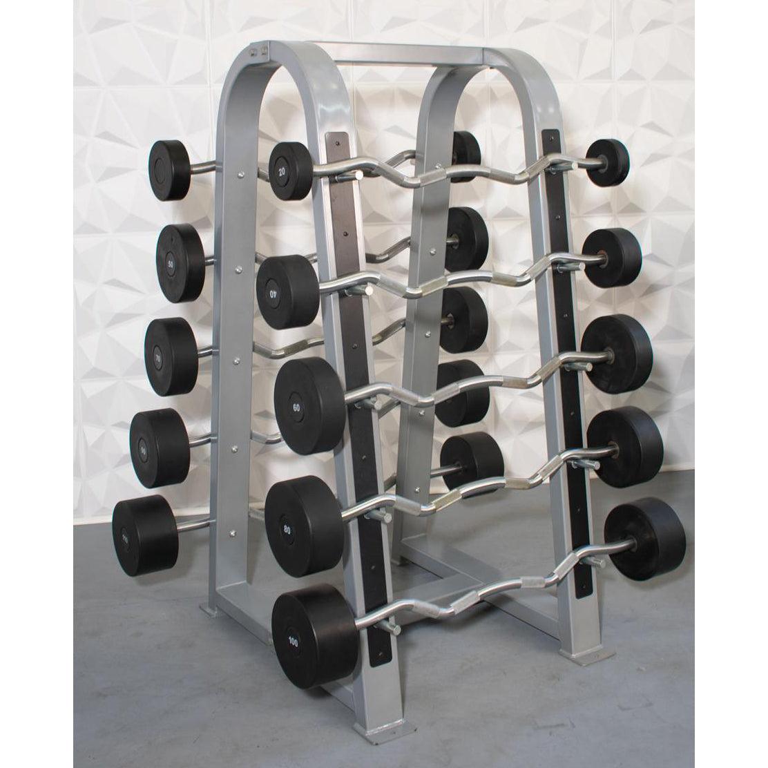 Rack with straight and curl barbells, black urethane weights, silver bars, against a white textured wall.