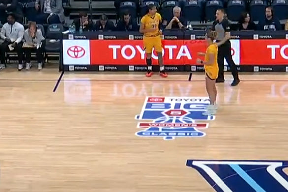Floor graphic of a Toyota-sponsored women's basketball classic logo on a hardwood court during a game