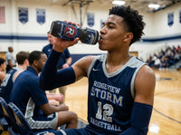 Thumbnail for Basketball player in a navy jersey drinking from a custom water bottle with a red and blue logo.