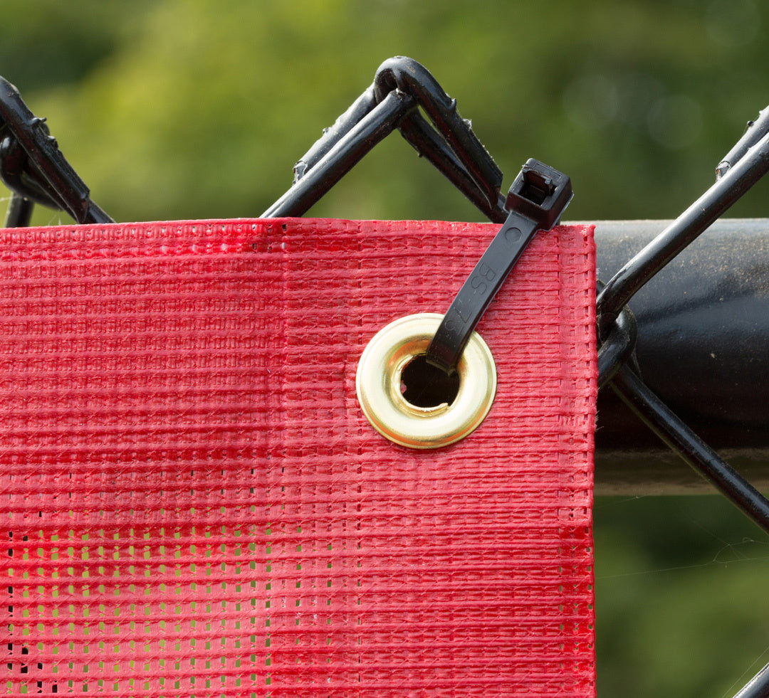 Cable tie secures grommet to chain link fence