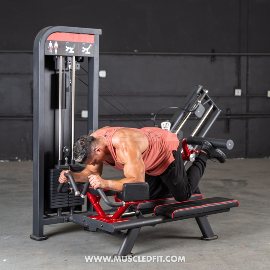 Man using a selectorized glute kick machine, performing a leg kickback exercise.