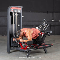 Thumbnail for Man using a selectorized glute kick machine, performing a leg kickback exercise.