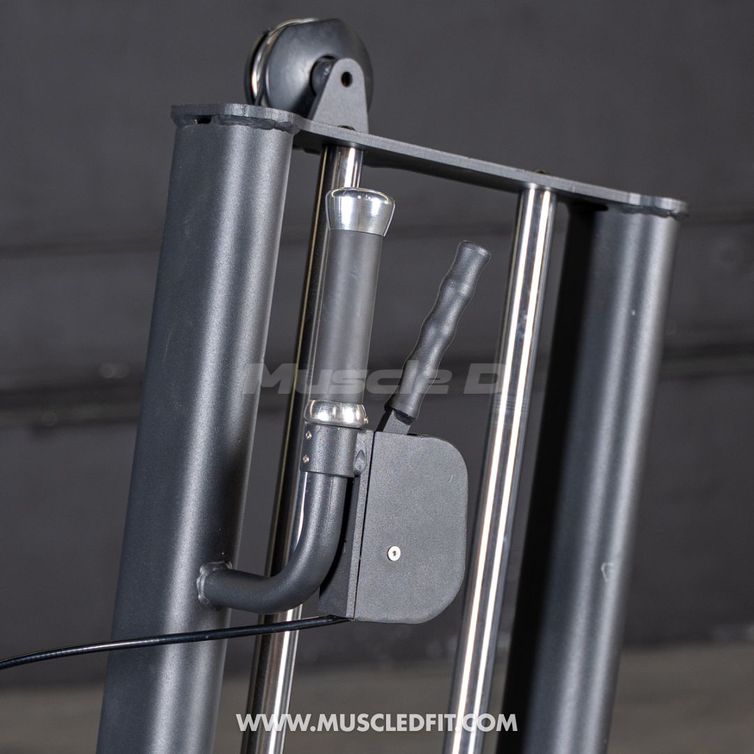 Close-up of a black selectorized glute kick machine, showing the handle, weight stack pin, and pulley system.