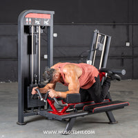 Thumbnail for Man using a selectorized glute kick machine, performing a leg extension exercise.