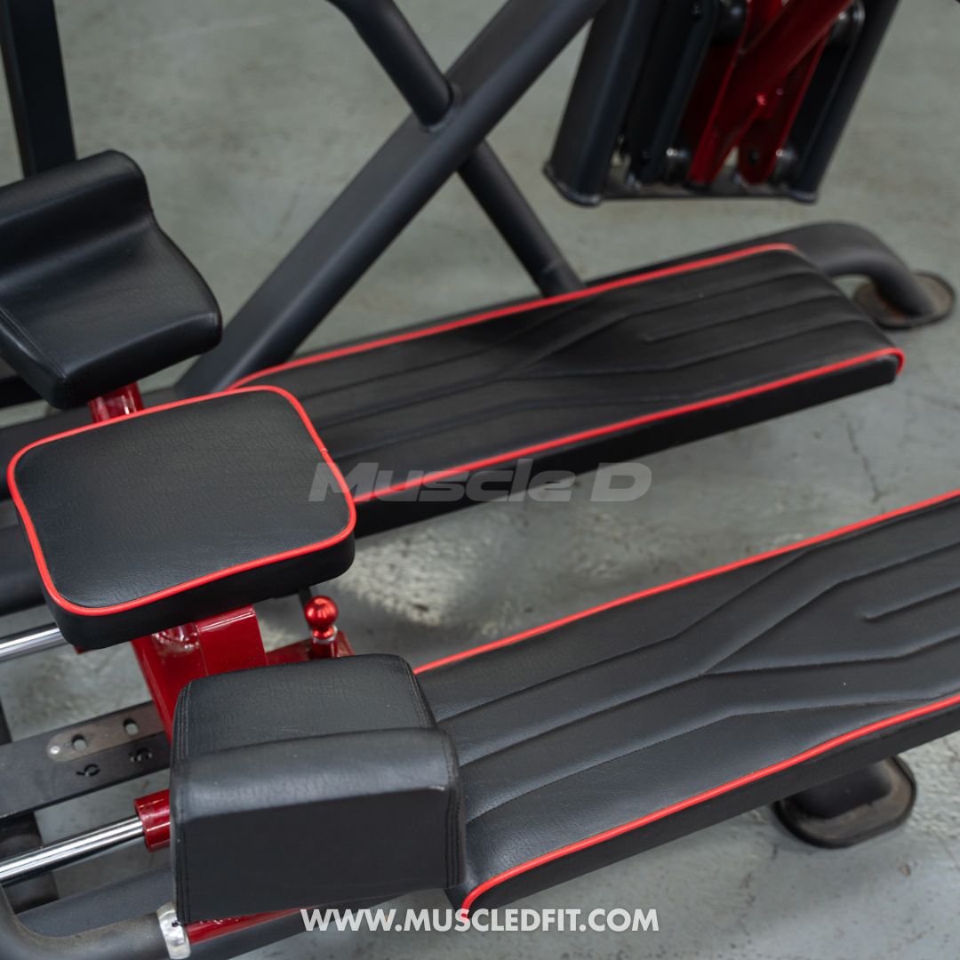 Close-up of black padded footrests and knee pads with red trim on a glute kick machine.