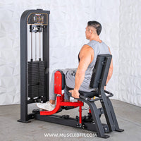 Thumbnail for Man using a black and red selectorized inner/outer thigh combo machine with weight stack.
