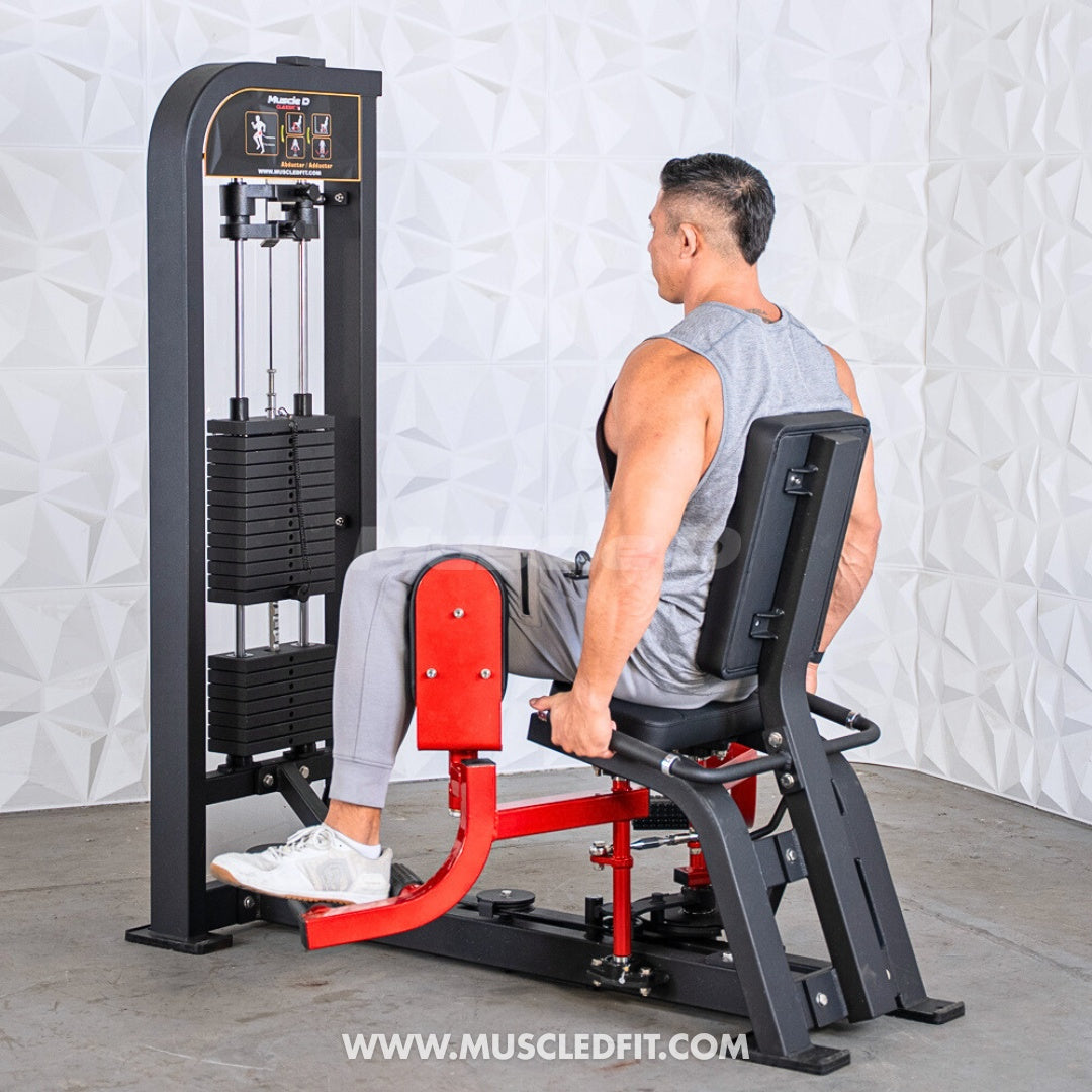 Man using a black and red inner/outer thigh combo machine with weight stack.